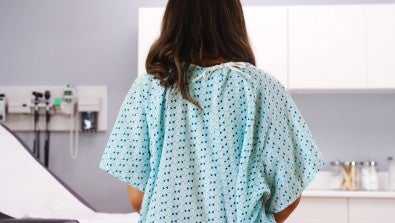 woman sitting in hospital gown