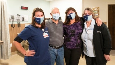 Rose Crochunis (pictured far right) stands with Chelsea McHugh, RN, John Daley and his wife Kelly Daley, RN.