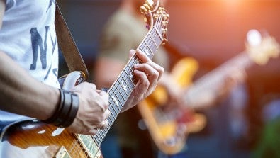 Guitarist playing on stage for crowd