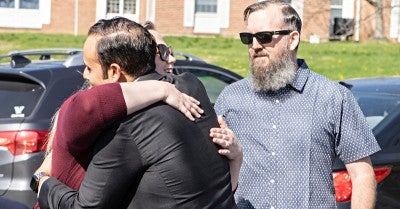 Shailendra Singh, MD, of Lehigh Valley Heart and Vascular Institute, hugs Jillian Byrne, while David Byrne (right) looks on.