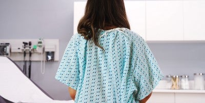 woman sitting in hospital gown