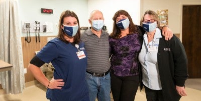 Rose Crochunis (pictured far right) stands with Chelsea McHugh, RN, John Daley and his wife Kelly Daley, RN.