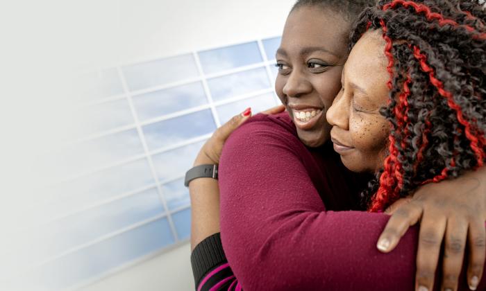 Women smiling and hugging