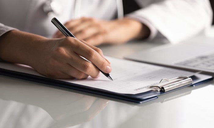 Clinician writing in chart