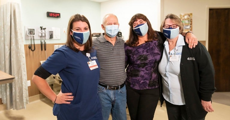 Rose Crochunis (pictured far right) stands with Chelsea McHugh, RN, John Daley and his wife Kelly Daley, RN.