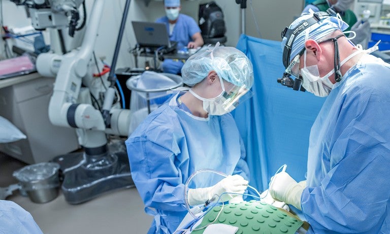 Clinicians performing surgery